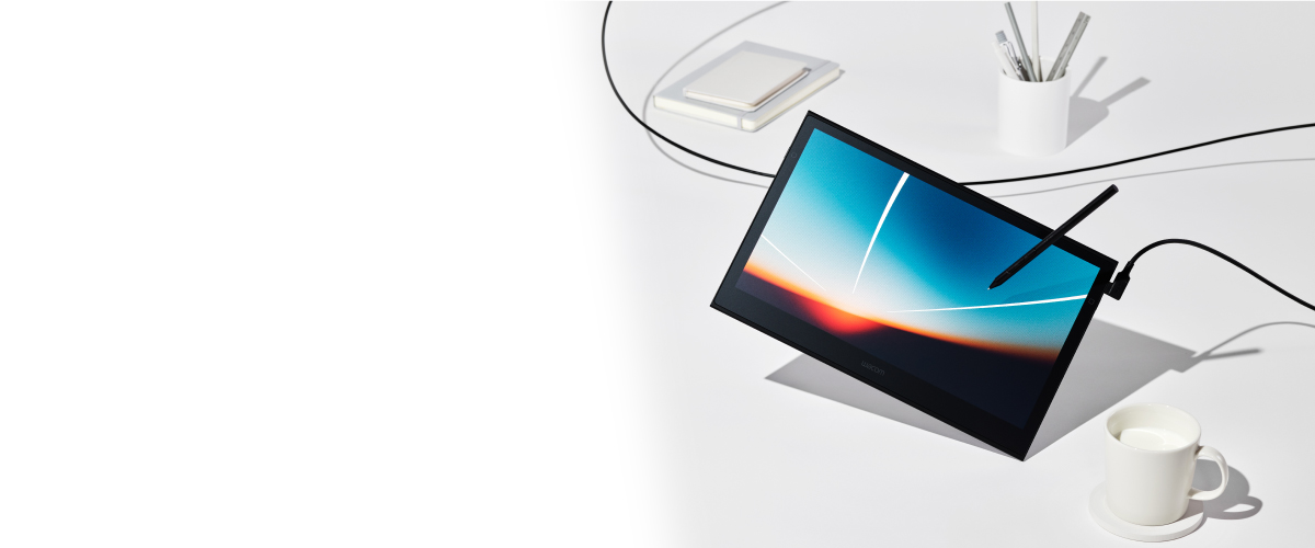 Wacom Movink featuring a vibrant image on its pen display. Tablet is levitating on white table with office supplies.